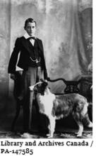 Archie Belaney at the age of 13 standing next to a dog in 1901. Later, he became known as Grey Owl.